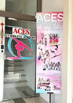 Aces Gymnastic Academy entrance at TPK Park with glass-door signage and promotional banner